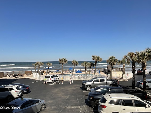 uncovered parking lot with a water view