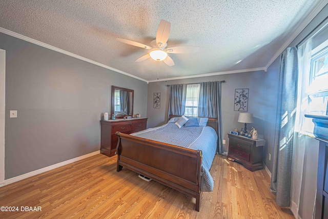 bedroom featuring a textured ceiling, light hardwood / wood-style floors, ceiling fan, and crown molding