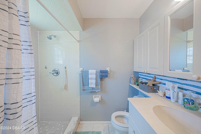 bathroom featuring toilet, vanity, tile patterned flooring, and curtained shower