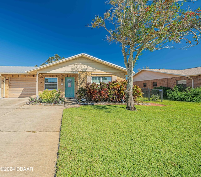 single story home with a front lawn and a garage