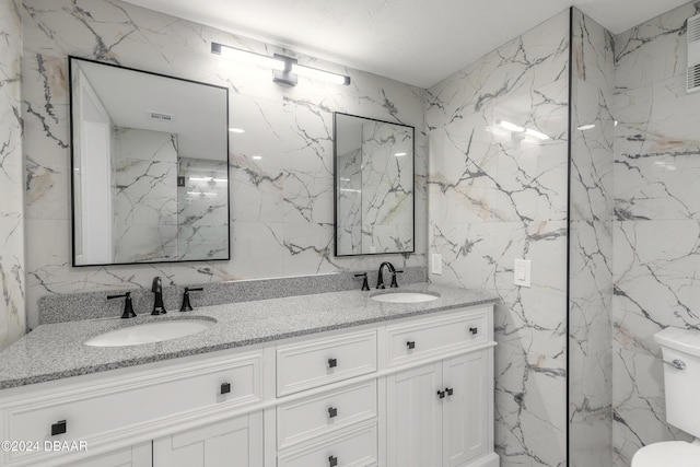 full bath with stone wall and a sink