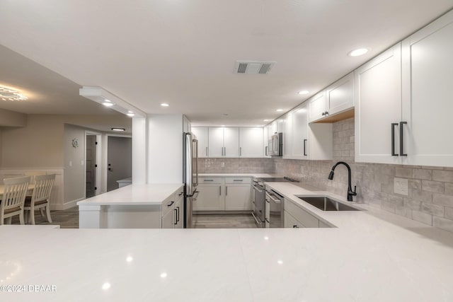 kitchen with light countertops, a sink, visible vents, and stainless steel appliances