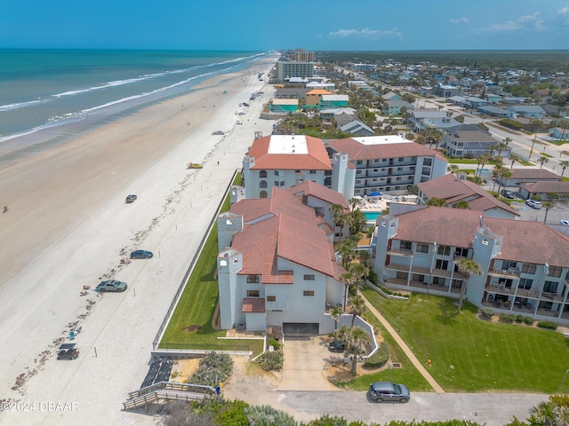 birds eye view of property with a beach view and a water view