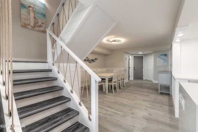 stairs featuring wood finished floors