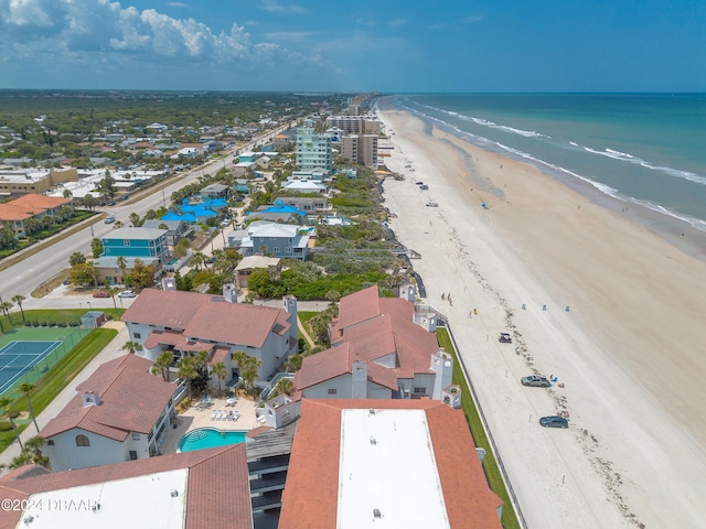 birds eye view of property featuring a water view and a beach view