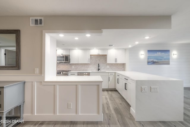 kitchen featuring a sink, visible vents, white cabinets, light countertops, and appliances with stainless steel finishes