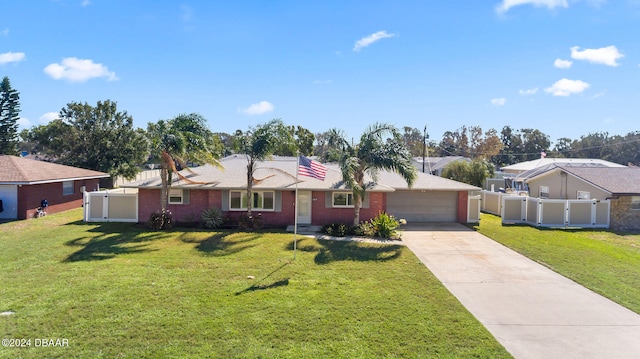 ranch-style home featuring a garage and a front lawn