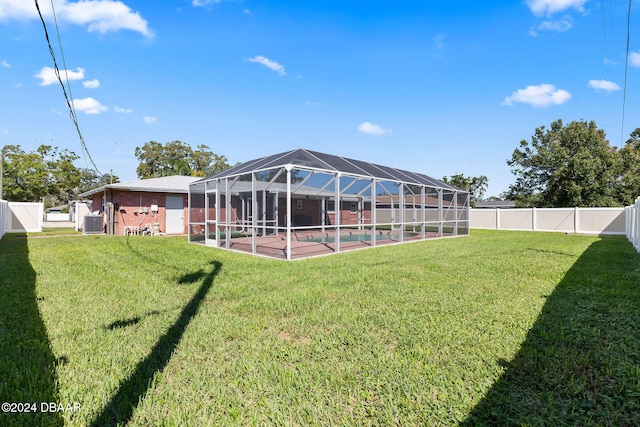 view of yard featuring a patio, a pool, and glass enclosure