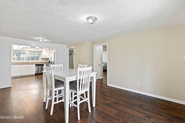 dining space with dark hardwood / wood-style flooring and sink