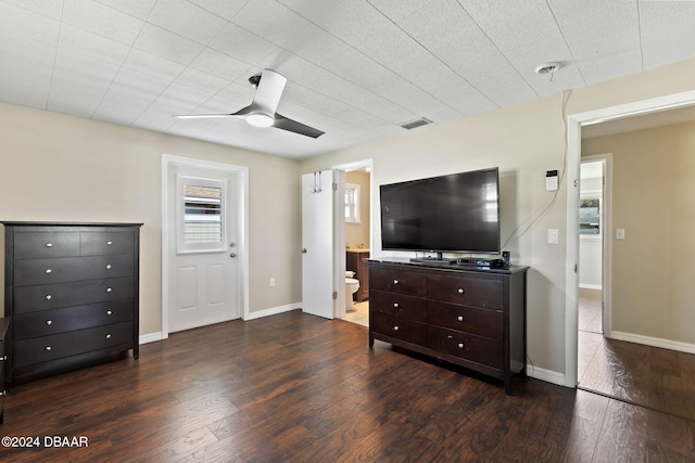 living room featuring ceiling fan and dark hardwood / wood-style floors