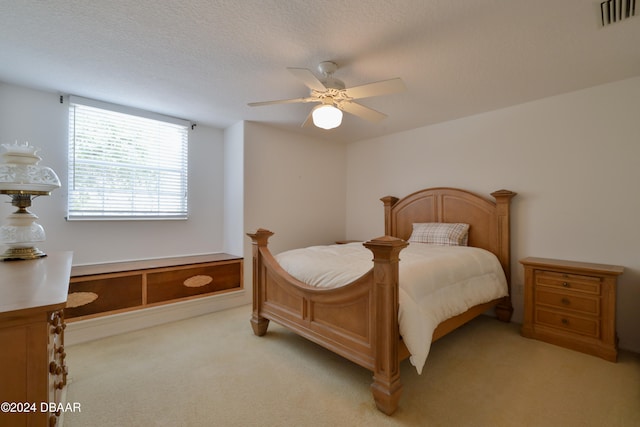 bedroom featuring light colored carpet and ceiling fan