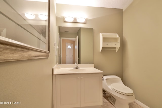 bathroom with tile patterned floors, vanity, and toilet