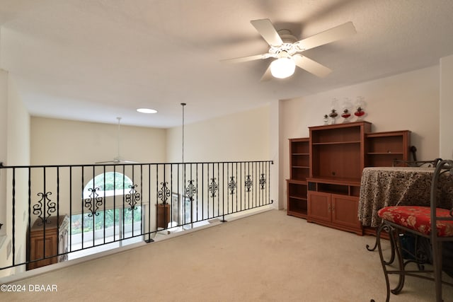 sitting room with ceiling fan and carpet floors