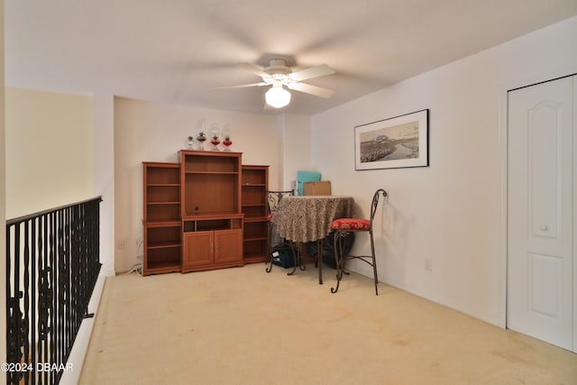 home office featuring ceiling fan and light colored carpet