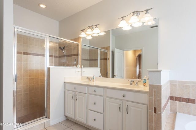 bathroom with tile patterned flooring, vanity, shower with separate bathtub, and a textured ceiling