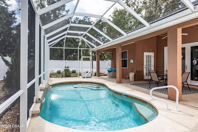 view of pool featuring a lanai, pool water feature, and a patio