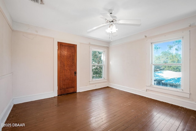 empty room featuring ceiling fan and dark hardwood / wood-style flooring