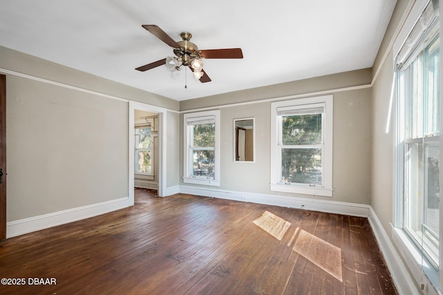 empty room with dark hardwood / wood-style flooring and ceiling fan