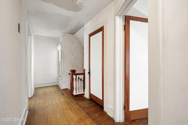 corridor with hardwood / wood-style floors