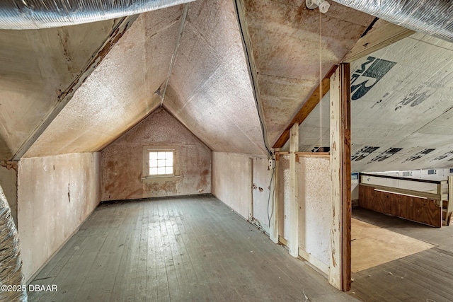 additional living space with vaulted ceiling and light hardwood / wood-style floors