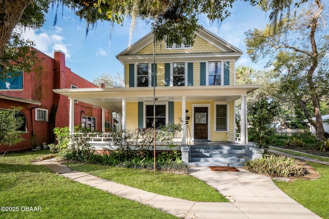 view of front of home with a porch and a front lawn