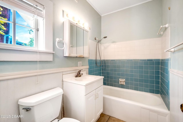 full bathroom with tiled shower / bath, vanity, toilet, crown molding, and tile patterned floors