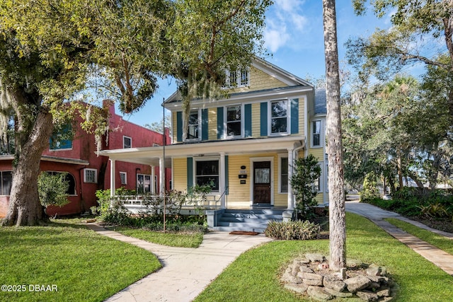 view of front of house with a front lawn and a porch