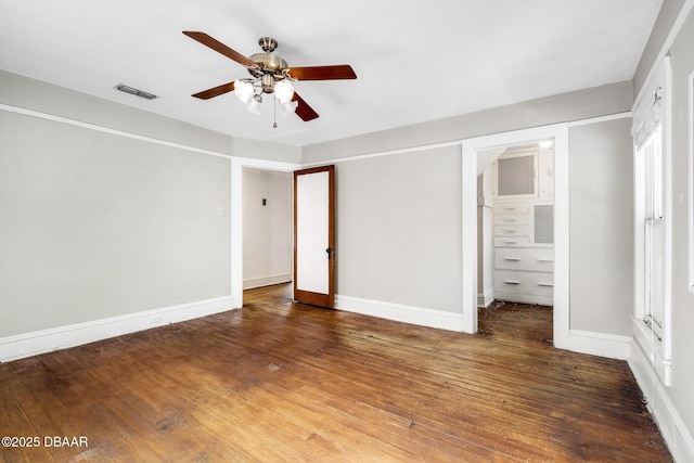 unfurnished bedroom with ceiling fan and dark hardwood / wood-style flooring