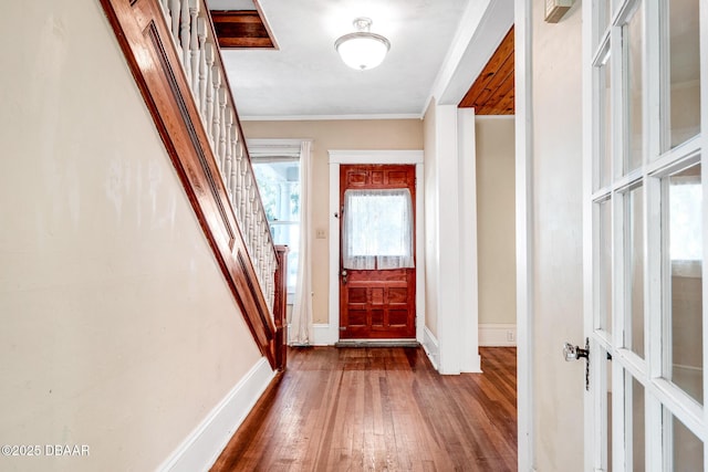 hallway featuring ornamental molding and wood-type flooring