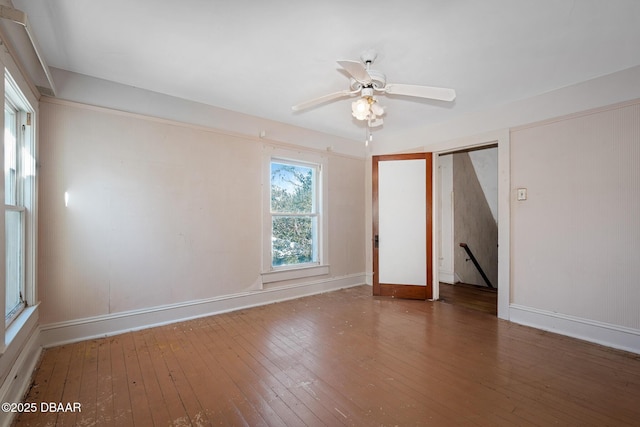 empty room with wood-type flooring and ceiling fan