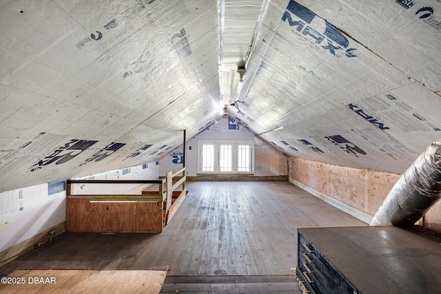 additional living space featuring wood-type flooring and vaulted ceiling