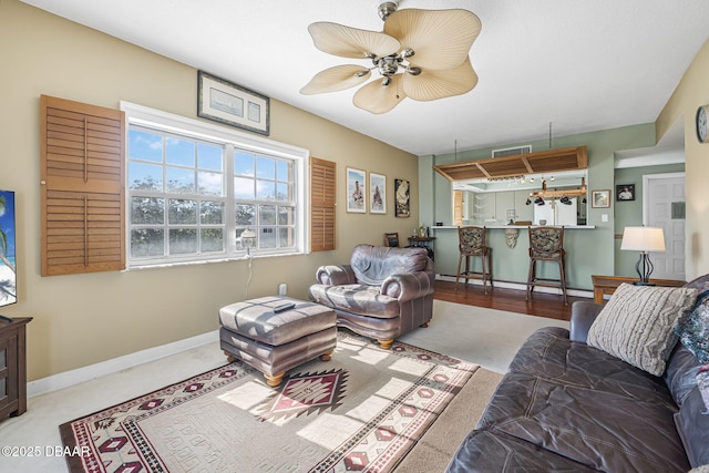 carpeted living room featuring ceiling fan