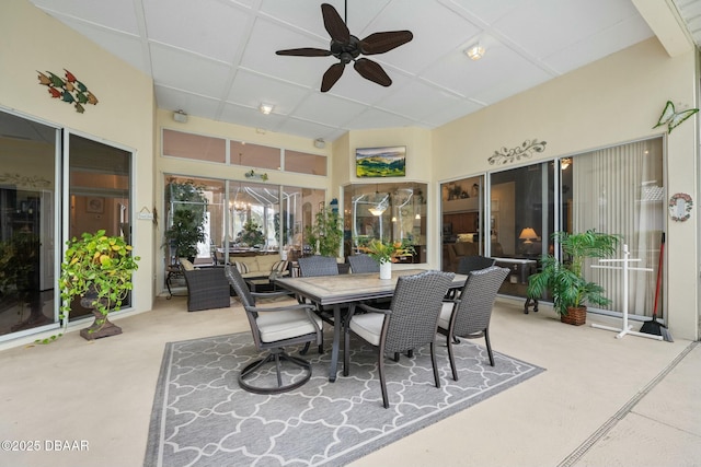 sunroom / solarium with a drop ceiling and ceiling fan