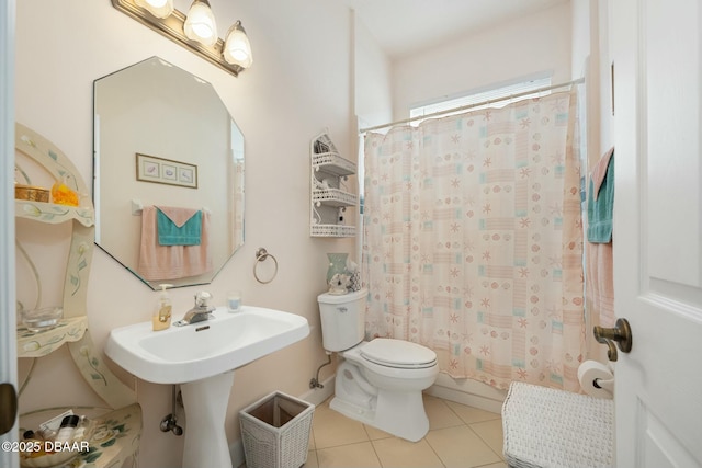 full bathroom with sink, shower / bath combo, tile patterned floors, and toilet