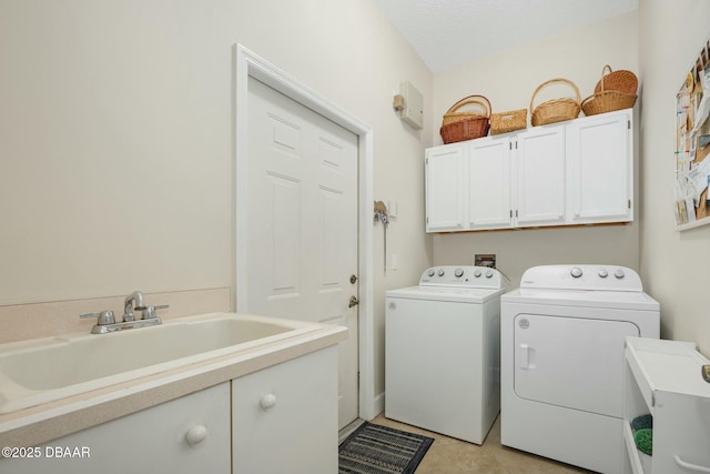 laundry area with independent washer and dryer, sink, and cabinets