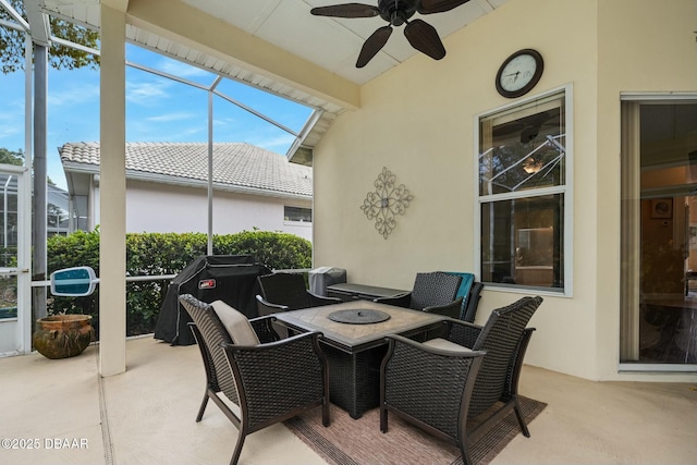 sunroom featuring ceiling fan