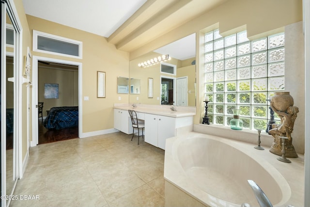 bathroom featuring tile patterned floors, vanity, and a bath