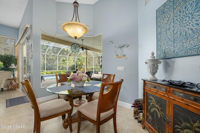 dining area with a high ceiling and light tile patterned floors