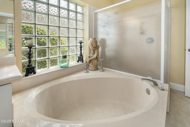 bathroom featuring tile patterned flooring and separate shower and tub