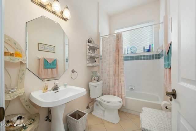 full bathroom with tile patterned flooring, sink, shower / tub combo with curtain, and toilet