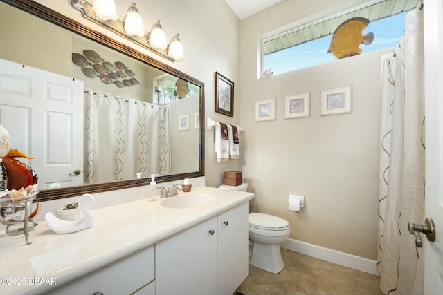 bathroom with tile patterned flooring, vanity, and toilet