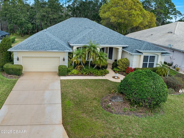 view of front of property with a garage and a front yard