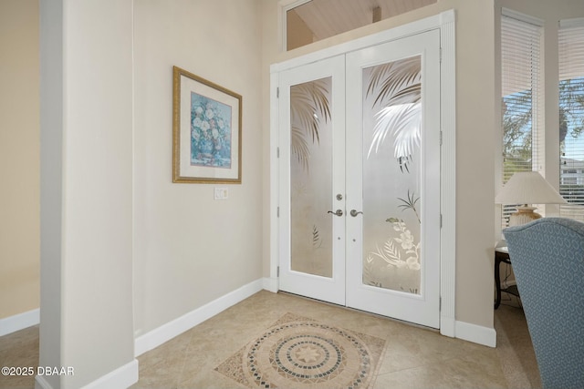 doorway to outside with light tile patterned floors and french doors