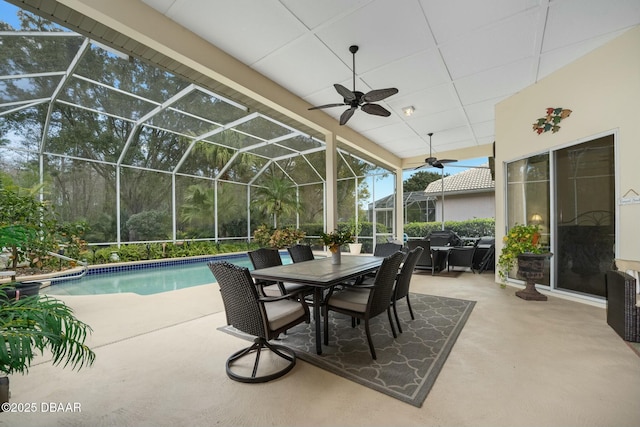 view of patio / terrace featuring ceiling fan and glass enclosure