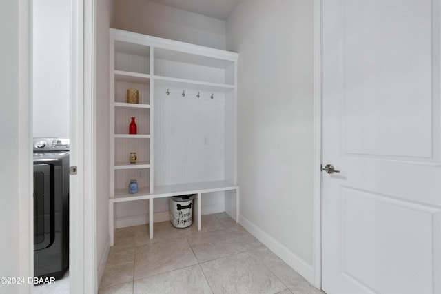 mudroom with light tile patterned floors and washer / dryer