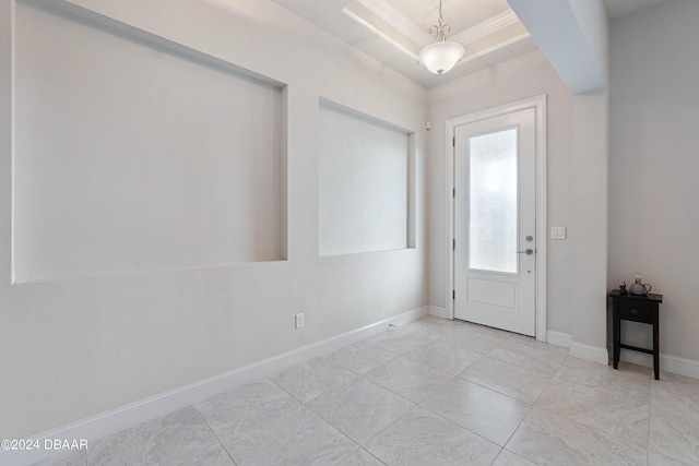 foyer with a raised ceiling