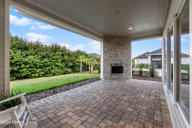 view of patio featuring an outdoor stone fireplace