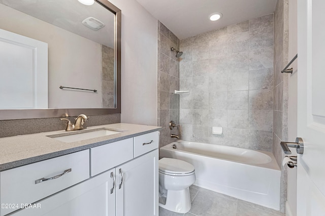 full bathroom with toilet, tiled shower / bath combo, vanity, and tile patterned flooring