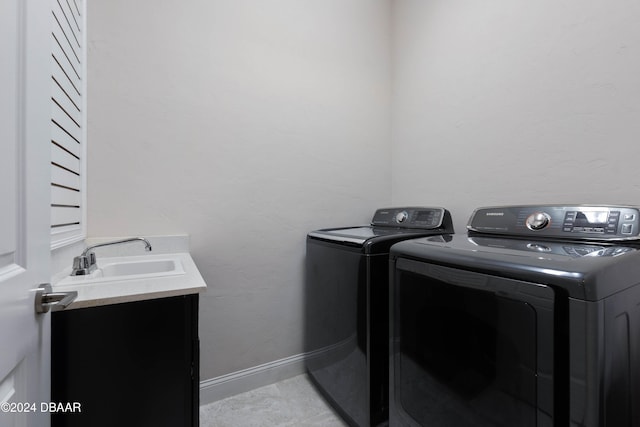 washroom with washing machine and clothes dryer and sink