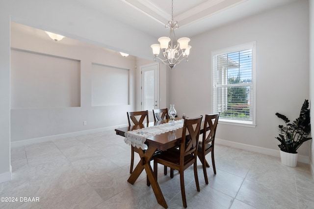 tiled dining room with a notable chandelier